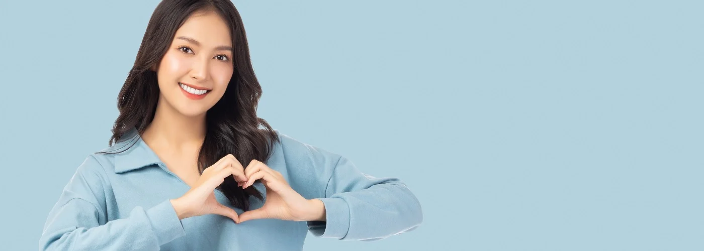 Woman making a heart shape with her hand
