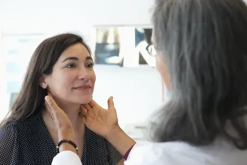 A patient undergoing a thyroid examination with an endocrinologist