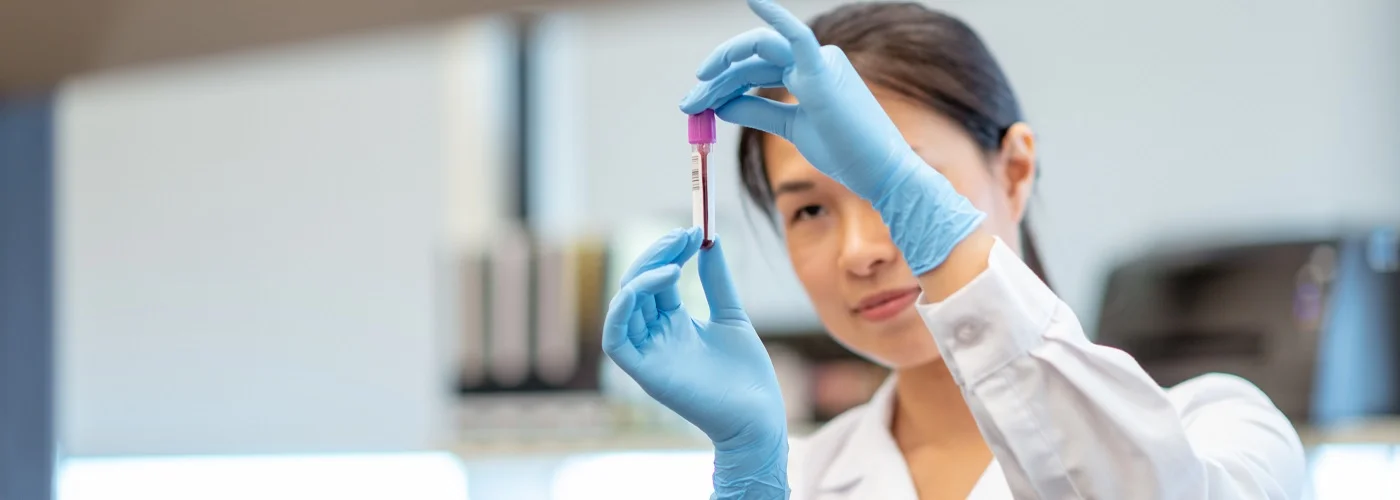 Haematologist analysing a blood sample in the lab