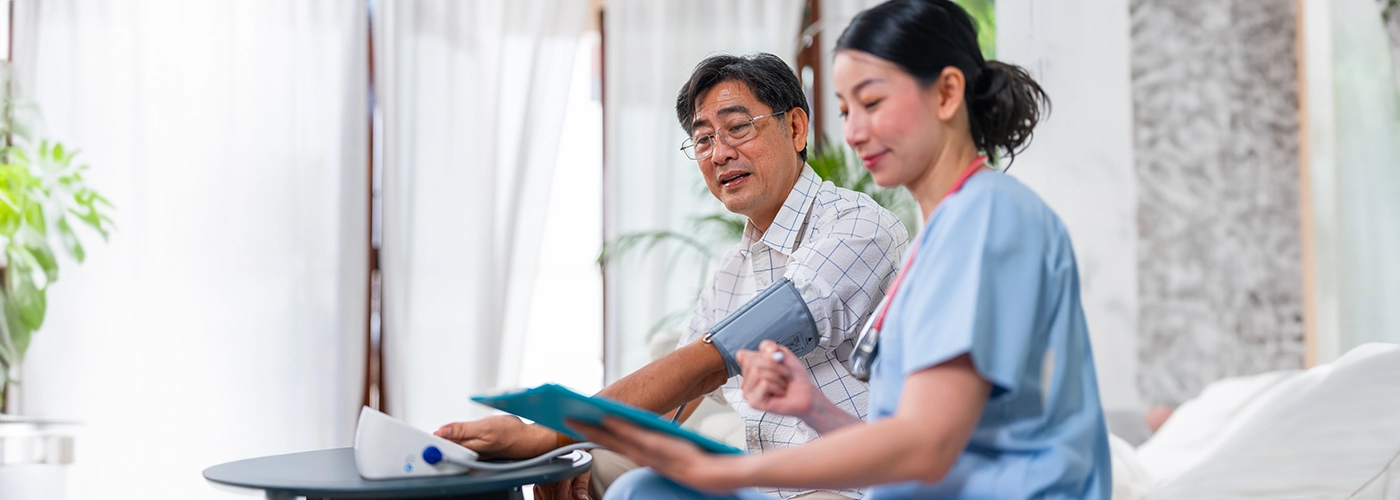 Nurse checking a man's blood pressure