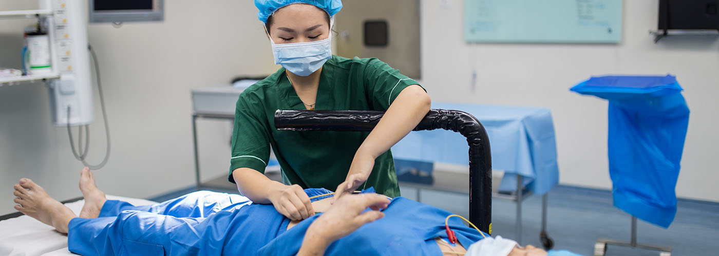 Healthcare professional preparing a patient for a gastroenterology procedure