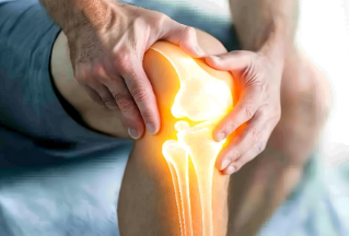 Person holding their knee with pain